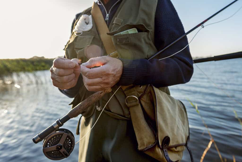 Close Up Of Fisherman's Hands Tying a Fly